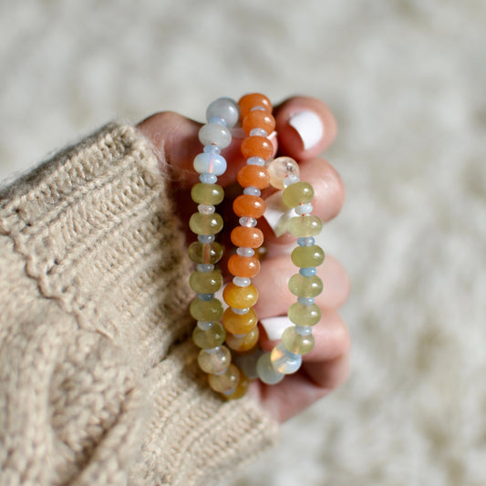Hand holding two beaded necklace