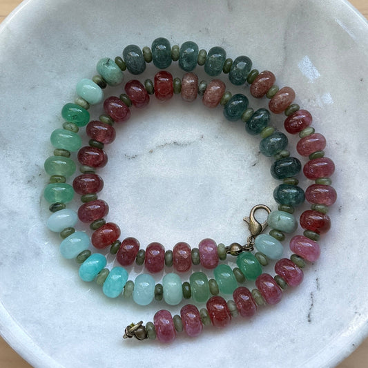 Beaded bracelet on a marble dish with a wooden background